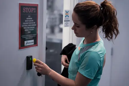 woman using GymMaster gym access control system