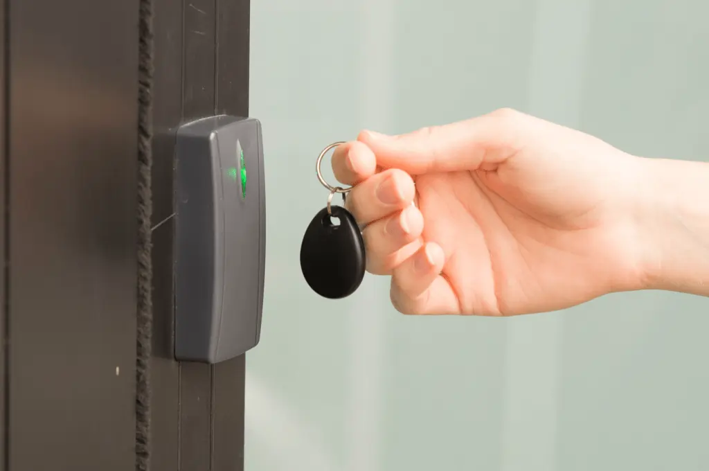 person swiping gym access control key tag